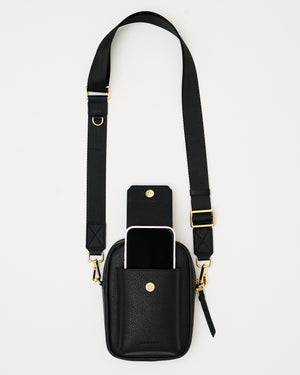 The Kristen Crossbody Genuine Leather Black Bag with Cross Body Nylon Adjustable Shoulder Strap, Phone pocket made to fit all and any iPhone Size with case on with magnetic snap shut closure, main compartment with secure zipper closure and roomy compartment made to fit all essentials, back passport sleeve, and interior compartment. Perfect for any occasion, travel / airport, and everyday wear.