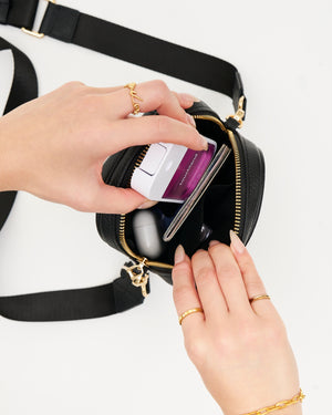 The Kristen Crossbody Genuine Leather Black Bag with Cross Body Nylon Adjustable Shoulder Strap, Phone pocket made to fit all and any iPhone Size with case on with magnetic snap shut closure, main compartment with secure zipper closure and roomy compartment made to fit all essentials, back passport sleeve, and interior compartment. Perfect for any occasion, travel / airport, and everyday wear.